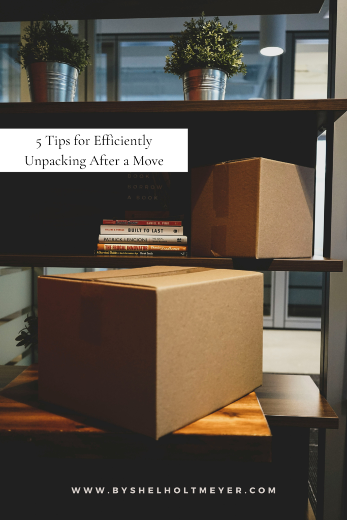 moving boxes stacked next to and on a table with a text overlay that states the blog title "5 tips for efficiently unpacking after a move"